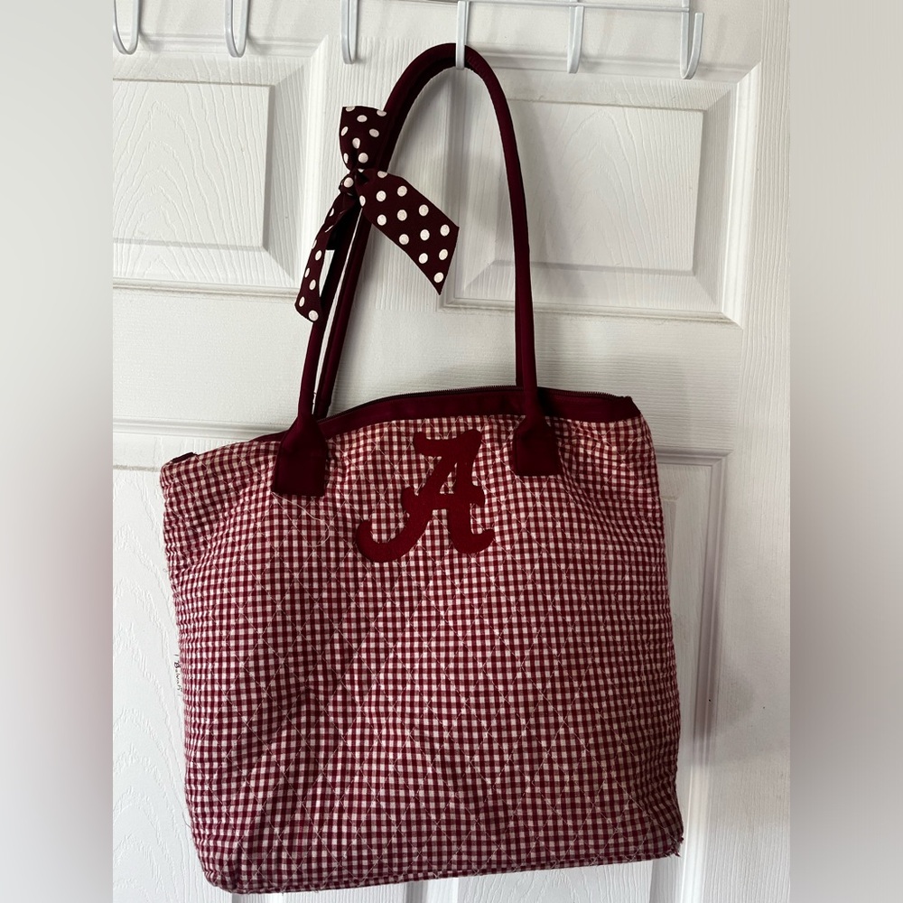 Quilted cranberry shoulder bag with embroidered “A”